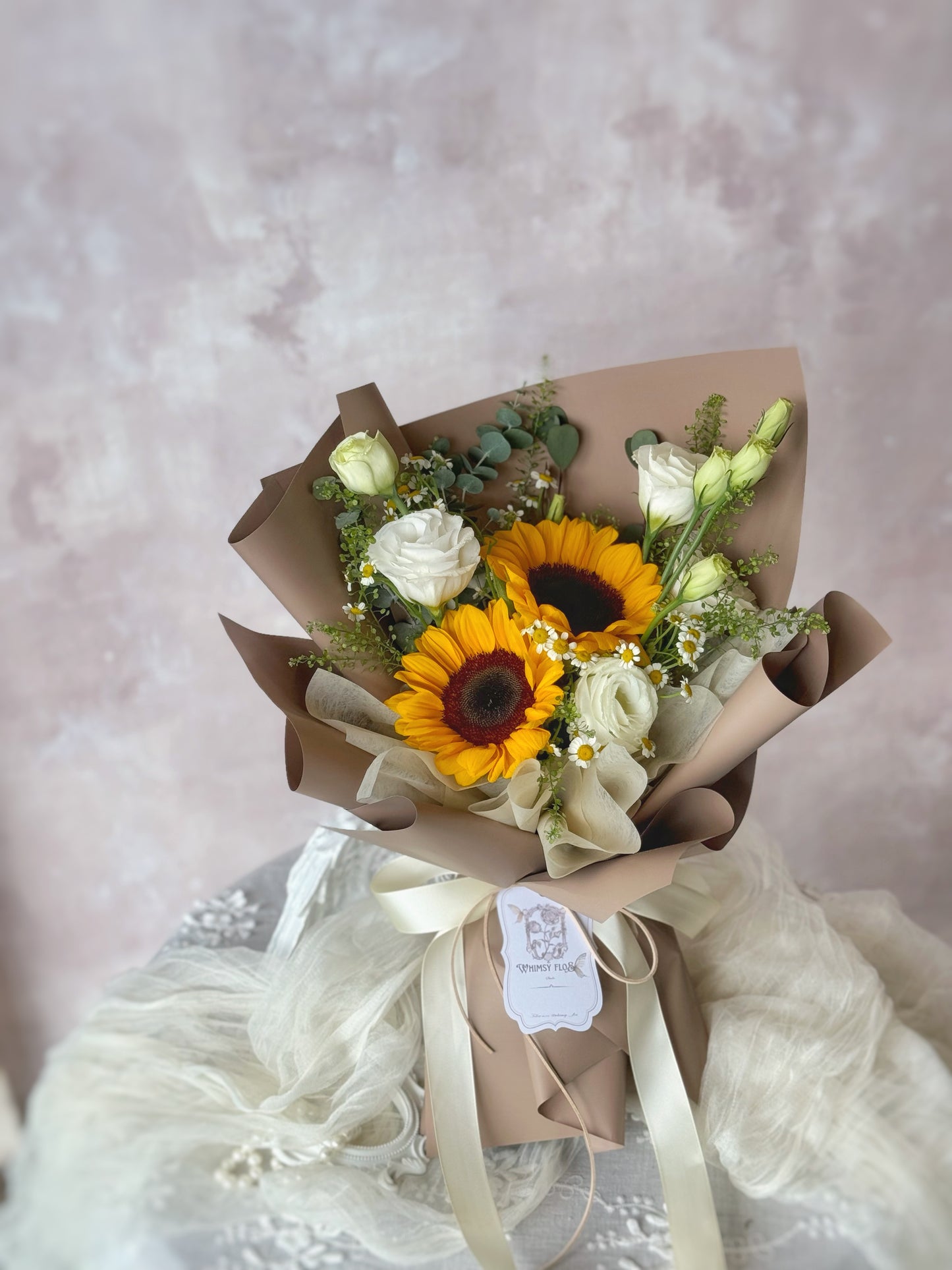 Stella fresh flowers handtied bouquet brown wrapping sunflower mix on the table