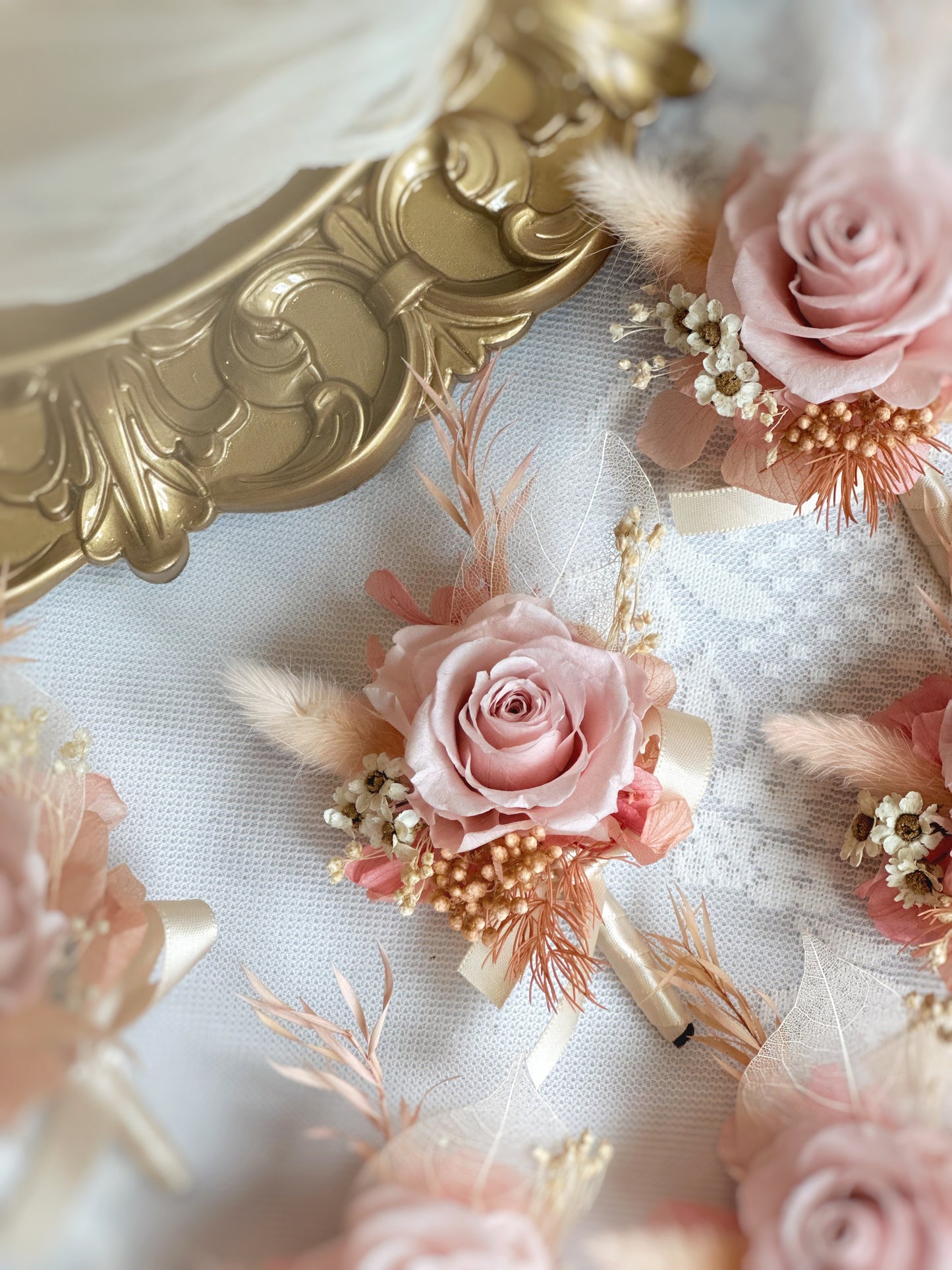 Close up view of tiana preserved flowers boutonniere, showing its details and delicate elements, perfect for pastel theme wedding or other events
