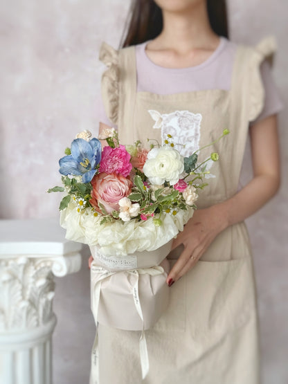 weekly flowers round bouquet holding by a model