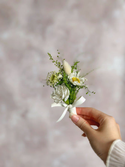 holding 'creamy meadow' fresh flowers boutonniere, front view