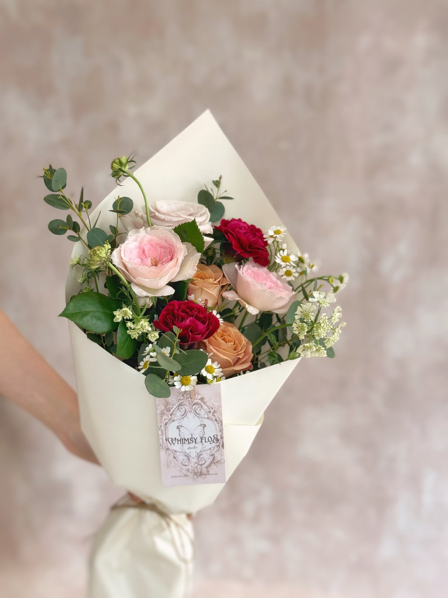 Model casually holding the bouquet in one hand, showing its carefree elegance and easy giftability.
模特单手轻松持花，展现花束自然优雅的气质，是一份简单却暖心的花礼。