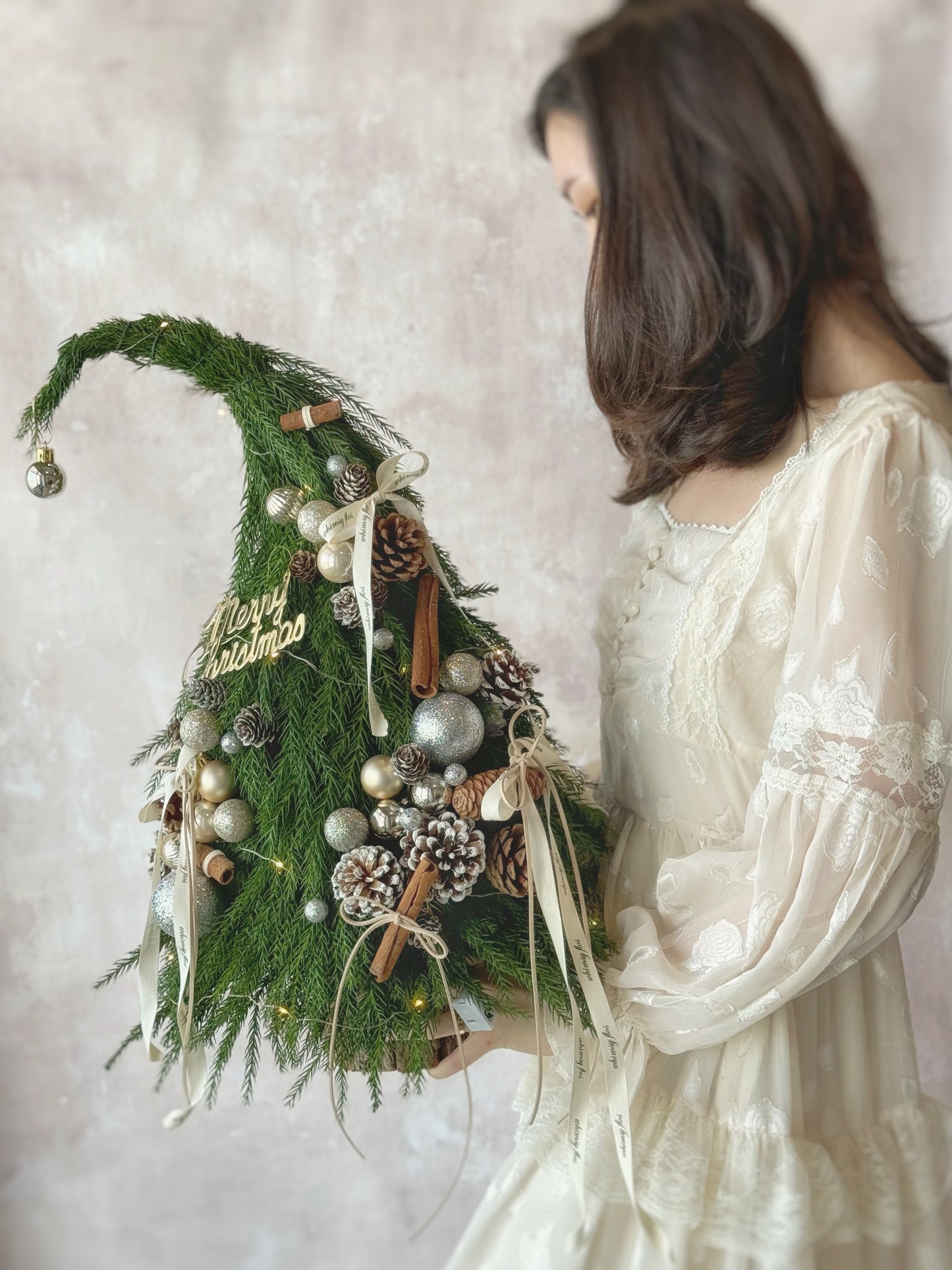 Front view of the Grinch Tree, a 50cm fresh pine Christmas arrangement with festive ornaments and LED lights.
