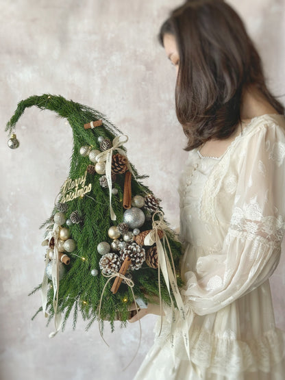 Front view of the Grinch Tree, a 50cm fresh pine Christmas arrangement with festive ornaments and LED lights.